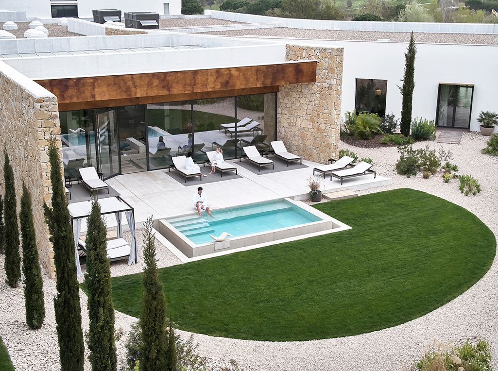 Aerial view of the spa garden with plunge pool, loungers and cypress trees