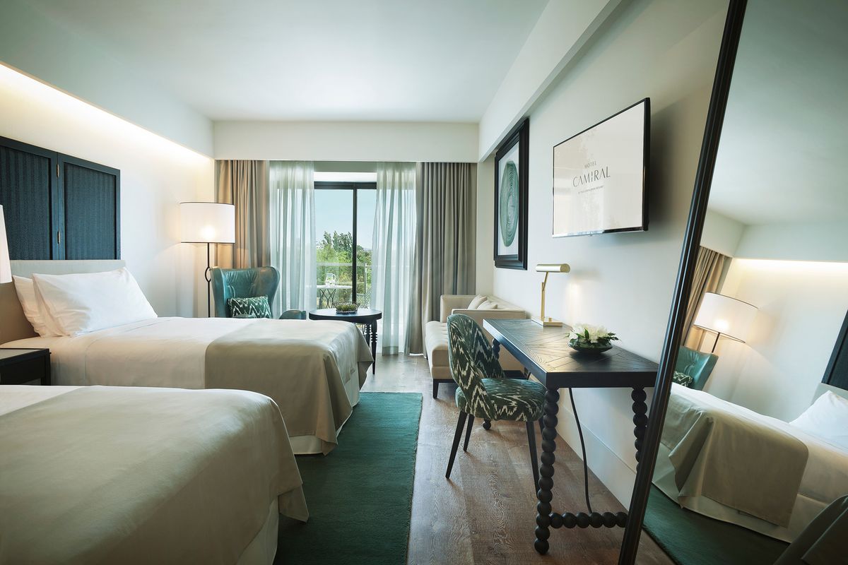 Superior Deluxe twin room with two beds and a desk by the window